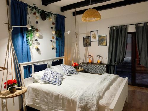 una camera da letto con un letto bianco con tende blu di Nordic Chalet a Sinaia