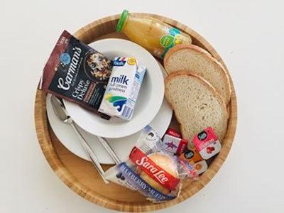 a plate of food with a plate of breakfast foods at Sandpiper Motel Ulladulla in Ulladulla