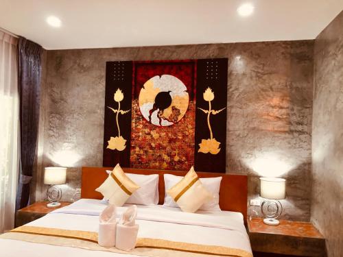 a bedroom with a bed and a painting on the wall at Nao Ta Chuang in Thung Song