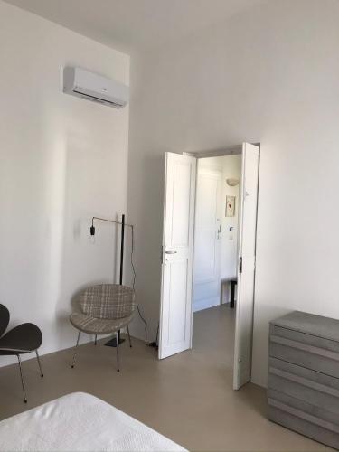 a room with a door and a chair and a table at La Casa di Bacco B&b in Alezio