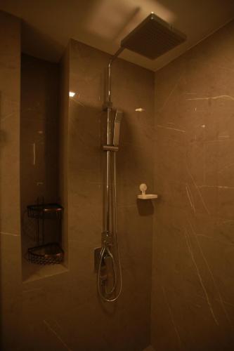 a bathroom with a shower with a shower head at HuaHin DusitD2 Residences, apartments near beach in Hua Hin