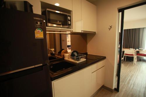 a kitchen with a sink and a microwave at HuaHin DusitD2 Residences, apartments near beach in Hua Hin