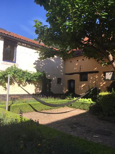 a house with a hose in front of it at De Zwarte Stok in Riemst