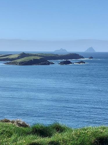 a large body of water with islands in the distance at Skellig Port Accommodation - 1 Studio Bed Apartment in Portmagee