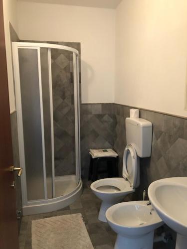 a bathroom with a shower and a toilet and a sink at Agriresidence San Pietro in Bibione