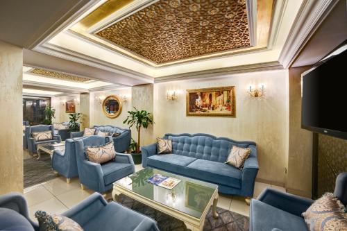 sala de estar con muebles azules y techo en Ayasultan Hotel, en Estambul