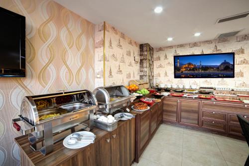 a kitchen with a buffet with food on it at Ayasultan Hotel in Istanbul