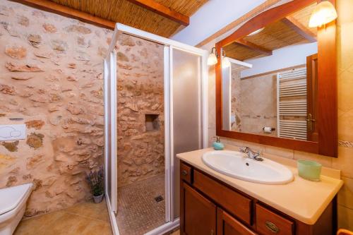 a bathroom with a shower and a sink at Cas Batlet Antonia in S'Horta