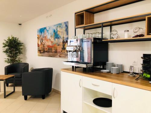 a kitchen with a coffee machine on a counter at ADAPT Apartments Braunschweig in Braunschweig
