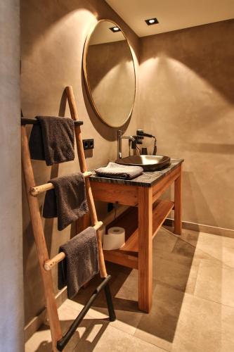 a bathroom with a sink and a mirror at Herz3 Hotel Bar Restaurant Trattoria in Hollersbach im Pinzgau
