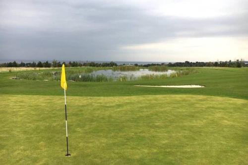 a yellow flag in the middle of a golf course at Edinburgh - Seton Sands-Cameo Caravan-Pet Friendly in Edinburgh