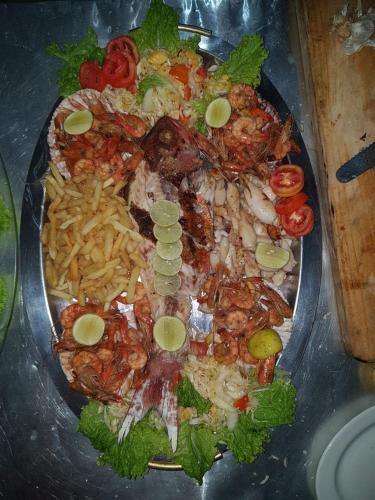 a plate of food with shrimp and french fries at Dreamvillage in Dodanduwa