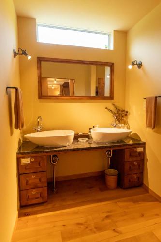 a bathroom with two sinks and a mirror at YOISAMA Sunset Beach House in Ishigaki Island