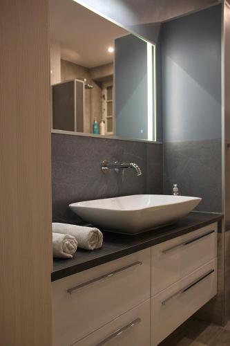 a bathroom with a white sink and a mirror at Sopot, BIG APARTMENT FOR 6!!! Air condition, jacuzzi in Sopot