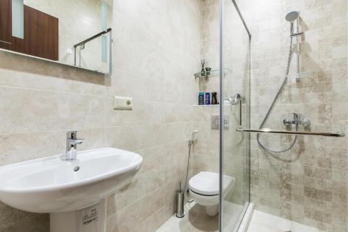 a bathroom with a sink and a toilet and a shower at Sweet Home 8 VIP at Freedom Square in Tbilisi City