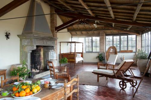 a living room with a table and a fireplace at Il Castello di San Michele in San Michele in Teverina
