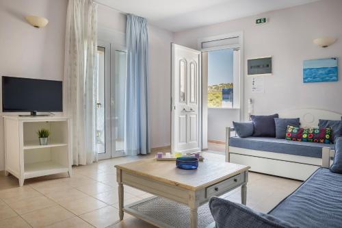 a living room with a couch and a table at ASTRA Village Resort in Svoronata