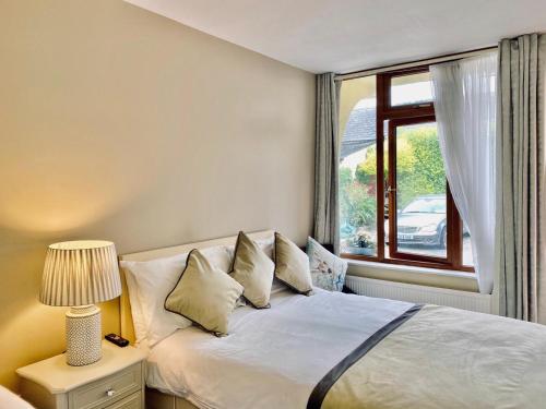 a bedroom with a white bed with a window at The Tower House B&B in Thomastown