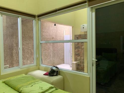 a room with a window and a bed in a room at Embay House & Private Pool in Bogor