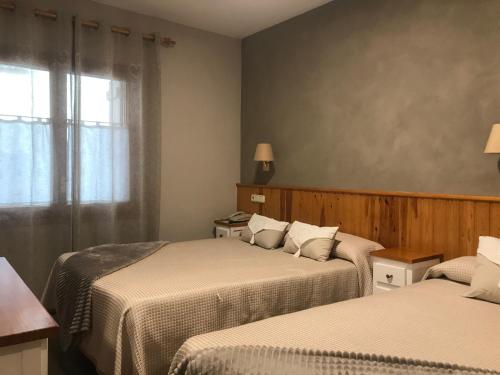 Un pat sau paturi într-o cameră la Hotel Casa Morlans