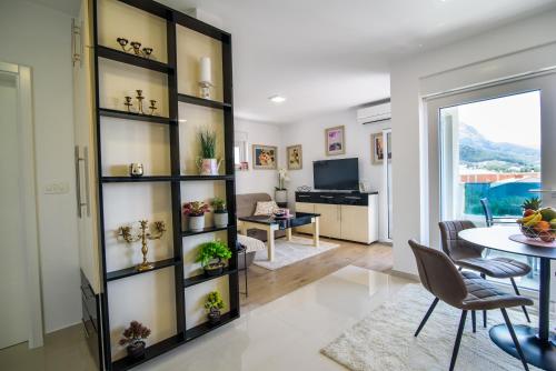 a living room with a large book shelf at Lorena Luxury Apartment in Makarska