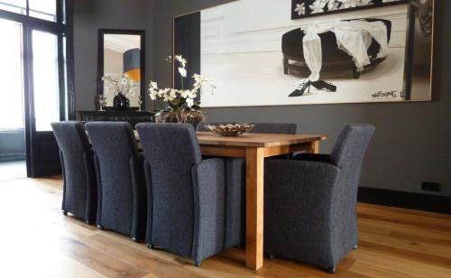 a dining room with a wooden table and chairs at Residenz Stadslogement in The Hague
