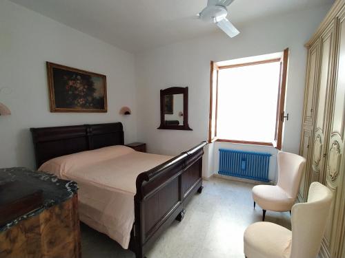 ヴェルナッツァにあるAgretta Sea View Apartmentのベッドルーム1室(ベッド1台、椅子、窓付)