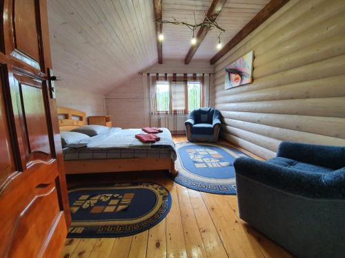 a bedroom with a bed and a chair in a cabin at Lucy in Yaremche
