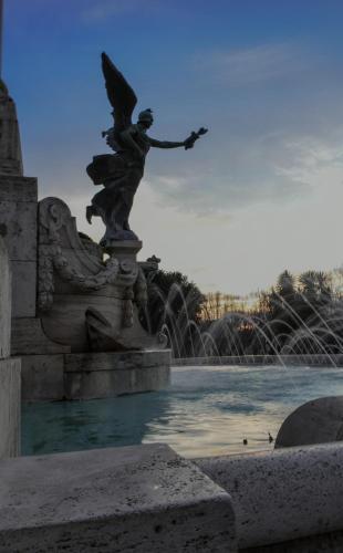 a statue of a woman with an umbrella on a fountain at Antica Terrazza Frascati in Frascati