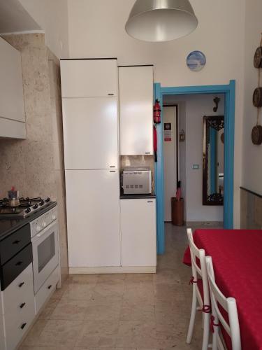 a kitchen with a white refrigerator and a table at Agretta Sea View Apartment in Vernazza