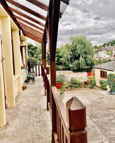 a balcony of a house with a view of a river at The Tower House B&B in Thomastown