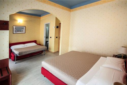 Postel nebo postele na pokoji v ubytování Hotel Fra I Pini
