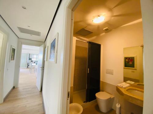 a bathroom with a sink and a toilet and a shower at La Villa nel Parco in Sanremo