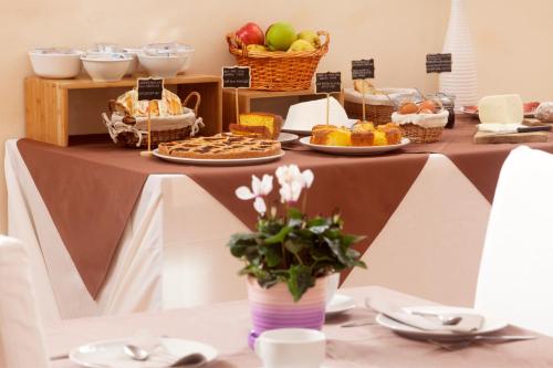 a table topped with food and baskets of fruit at Bio Agriturismo Le Cascatelle in Saturnia