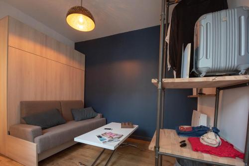 a living room with a couch and a bunk bed at Ma Location Sablaise - Appart' Arago in Les Sables-d'Olonne