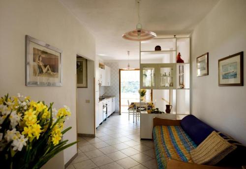 a living room with a couch and a kitchen at Casa degli Agrumi in Pomonte