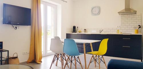 a kitchen with a table and four chairs at Côté Verdon in Quinson