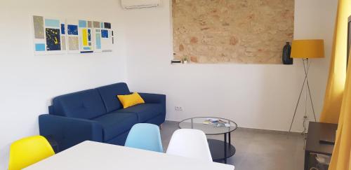 a living room with a blue couch and a table at Côté Verdon in Quinson