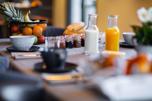 a table with food and bottles of orange juice at Les Mazots des Fées in Morzine