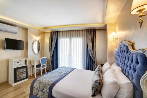 a hotel room with a bed and a television at Ayasultan Hotel in Istanbul