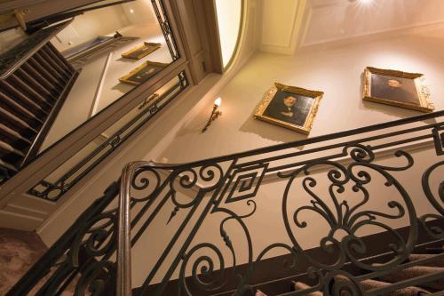 a staircase with pictures on the wall and a candle at Louise sur Cour in Brussels