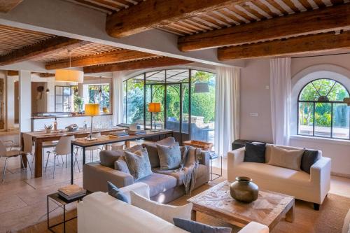 a living room with white couches and a table at Mas De Rosemarie in Joucas