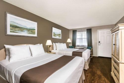 A bed or beds in a room at Super 8 by Wyndham Madison