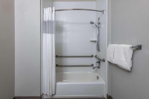 a bathroom with a shower and a white tub at La Quinta by Wyndham Fairbanks Airport in Fairbanks