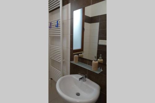 a bathroom with a sink and a mirror at Your House in Olbia