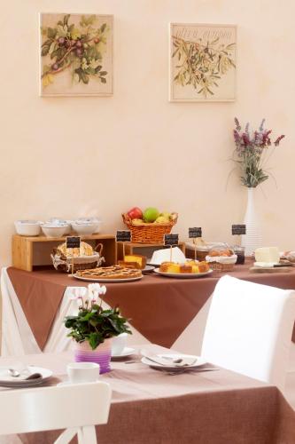 a table with a buffet of food and fruits at B&B Le Cascatelle di Saturnia in Saturnia