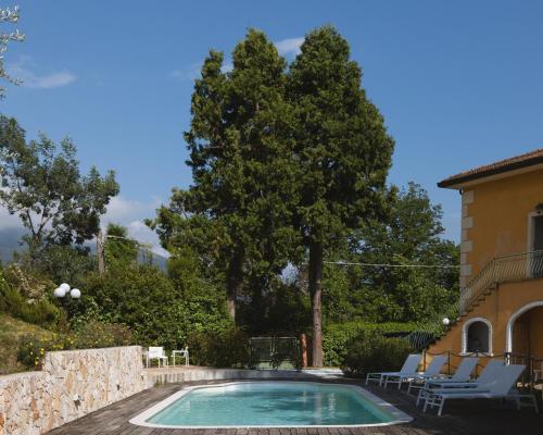 a swimming pool in front of a house at Villa Borgovecchio B&B in Camaiore