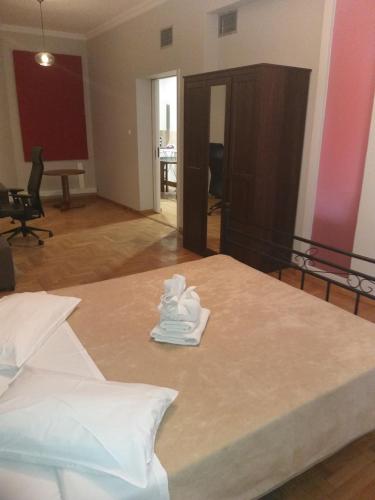a bedroom with a bed with white towels on it at Apollo Hotel in Athens