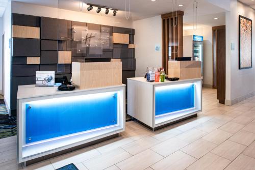 a lobby with two blue counters in a store at Holiday Inn Express & Suites - Elko by IHG in Elko