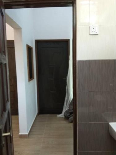 a door leading into a bathroom with a hallway at Captain's Cabin Resort - Naval Heritage (Swimming Pool) in Kota Bharu